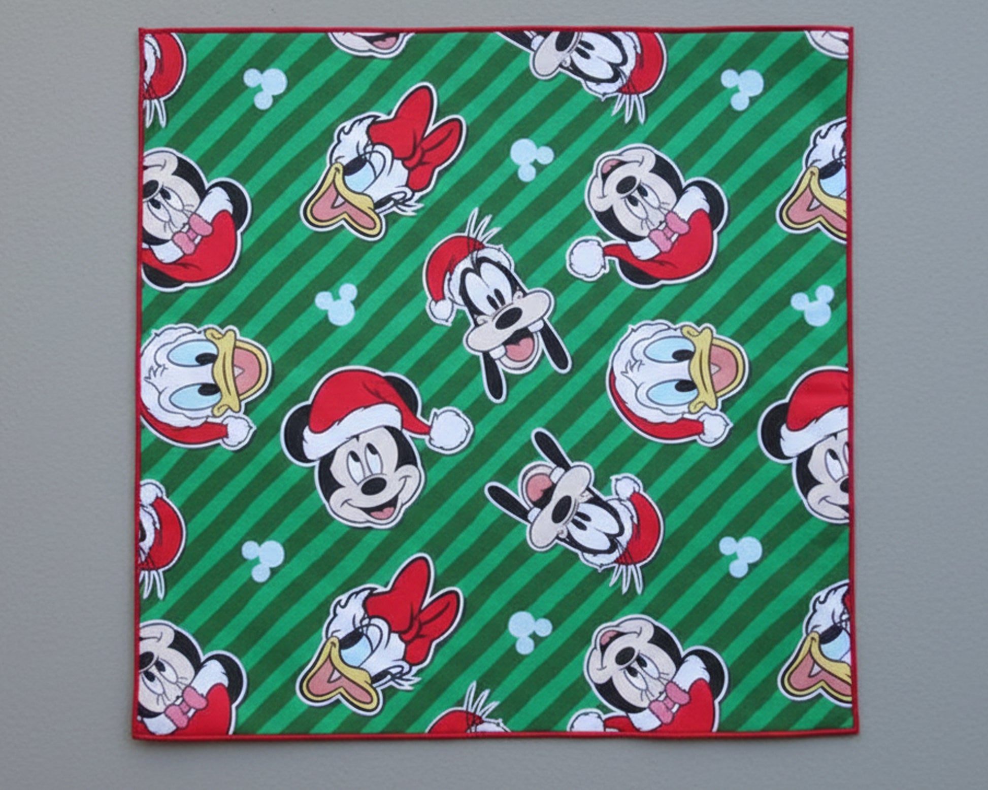 Single kids’ silky satin handkerchief featuring festive Mickey Mouse and friends on a green striped background.