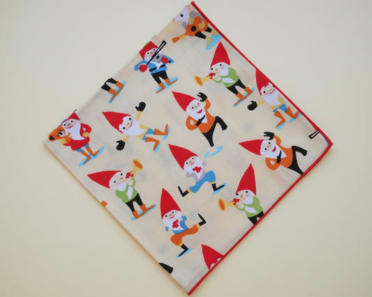 Single kids’ silky satin handkerchief featuring playful festive gnomes on a cream background.