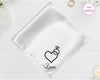 A shimmering pearl white luxury satin handkerchief personalized with the name "Liam" below an embroidered diamond ring with a heart-shaped stone.