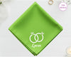 A fresh spring green cotton handkerchief featuring the name "Lucas" and white embroidery depicting two sparkling diamond rings entwined.