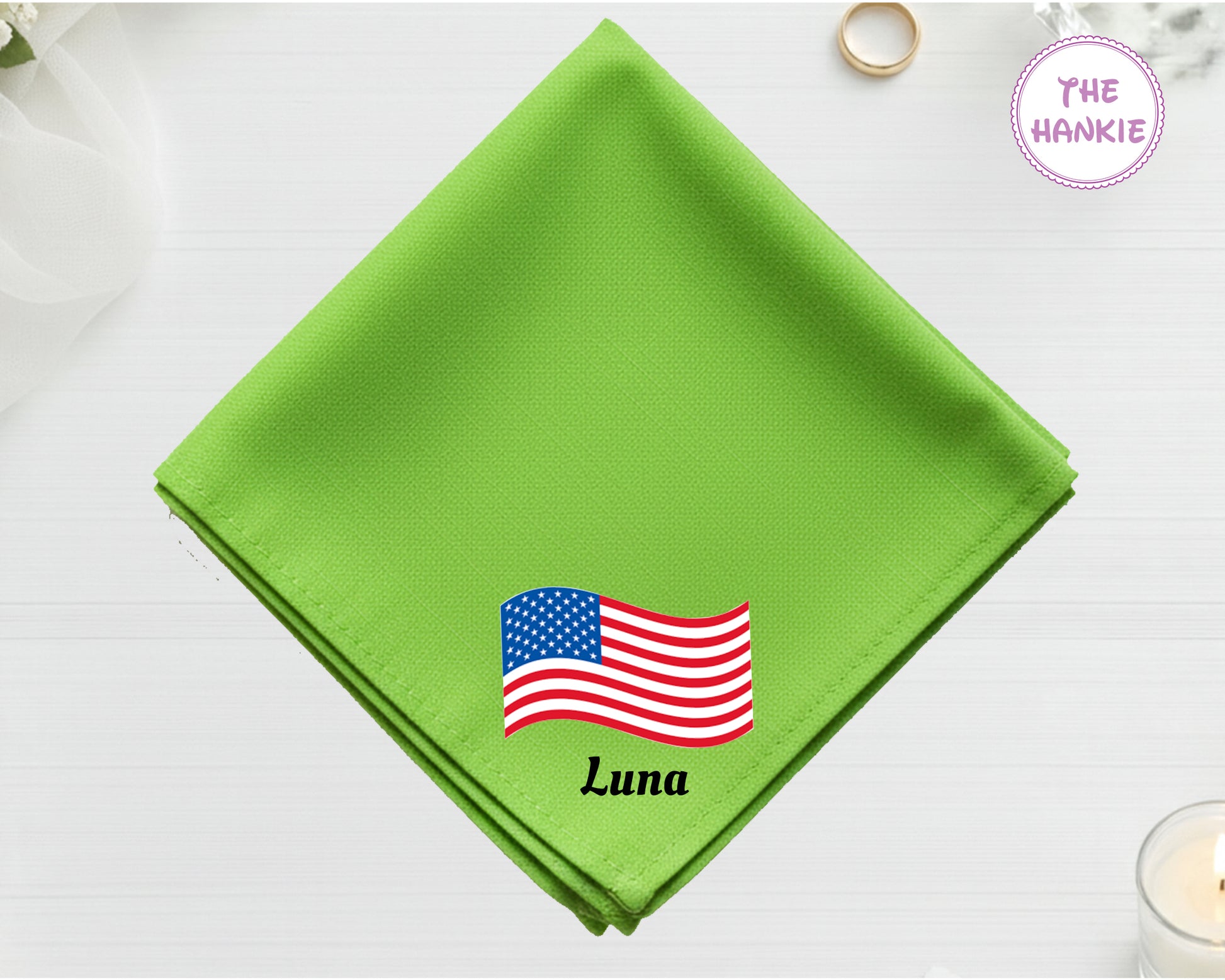 A spring green cotton handkerchief customized with the name "Luna" and a vibrant, waving American flag embroidery.