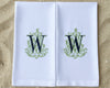 A set of matching white cotton napkins: one large dinner napkin and one small cocktail napkin with green monograms