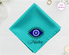 A vibrant turquoise cotton handkerchief customized with "Mateo" and a classic blue and white circular Nazar evil eye design.