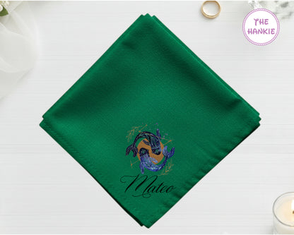 A lush forest green cotton handkerchief customized with "Mateo" below a mystical indigo and gold twin fish Pisces design.