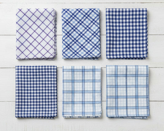 Overhead view of a 6-pack men's cotton handkerchief set featuring assorted blue gingham and plaid patterns on white wood.