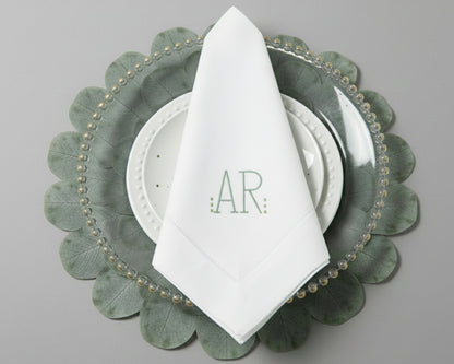 Personalized white dinner napkin with a minimalist sage green 'AR' monogram and hemstitch border detail