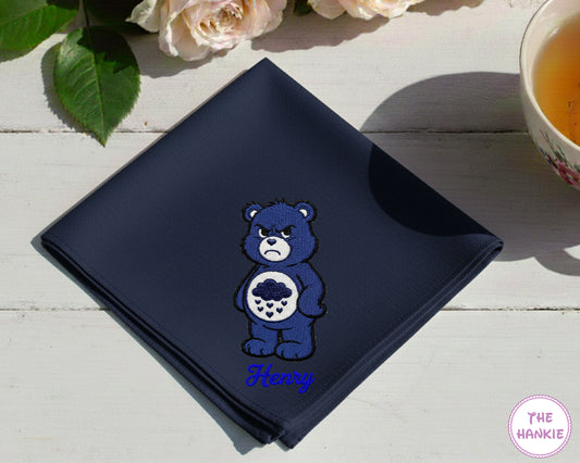 A luxurious navy blue satin handkerchief featuring the personalized script name "Noah" in purple alongside a detailed Harmony Bear embroidery.