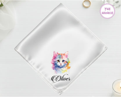 A shimmering pearl white satin handkerchief featuring the name "Oliver" below a soft-focus artistic kitten portrait in pastel tones.