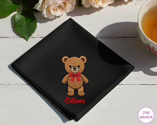 A premium jet black cotton handkerchief customized with the name "Oliver" and a detailed brown teddy bear wearing a red bow.