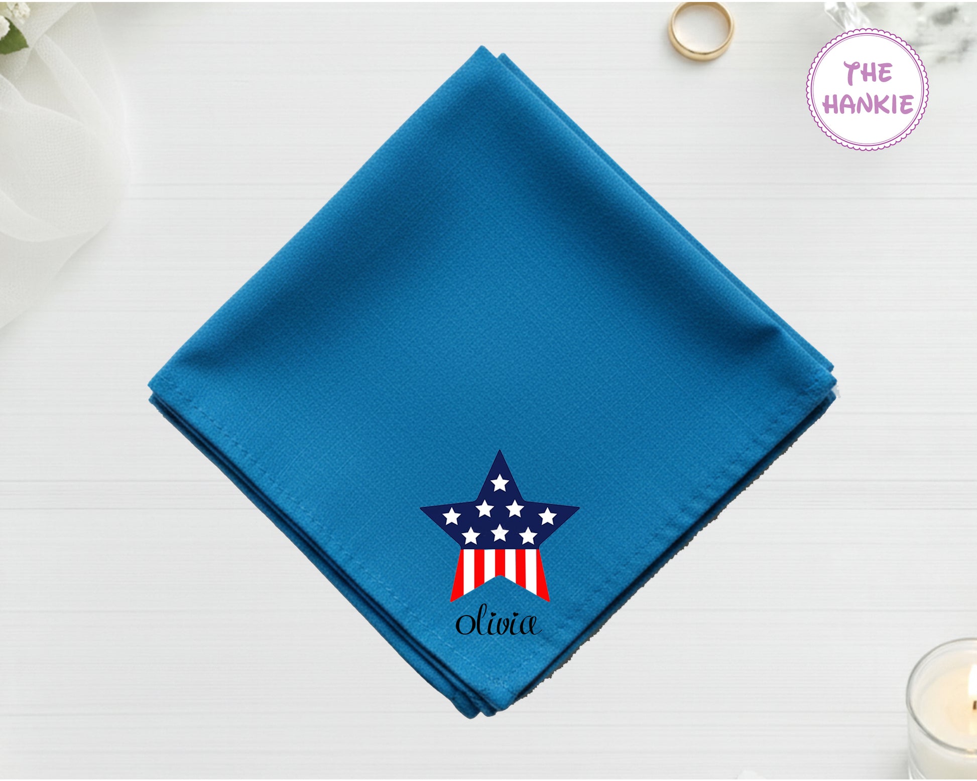 A deep navy blue cotton handkerchief customized with the name "Olivia" and a vibrant red, white, and blue American flag star design.
