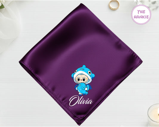 A deep purple premium satin handkerchief featuring a machine-embroidered blue shark-suit character and the name "Olivia".