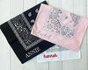 Three folded cotton bandanas in black, pink, and white featuring personalized names "ANNIE," "Rachel," and "hannah" in various embroidery styles.