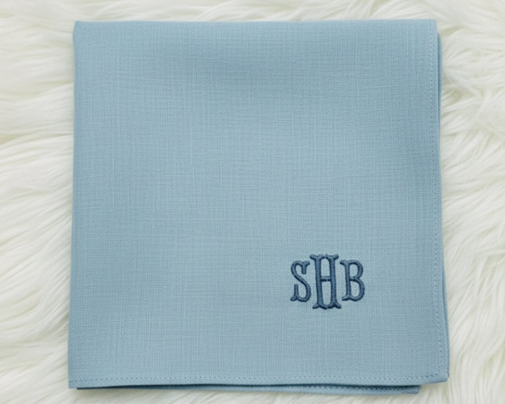A variety of personalized 100% cotton handkerchiefs in navy, sky blue, and white, showcasing different thread color options for custom monogramming.