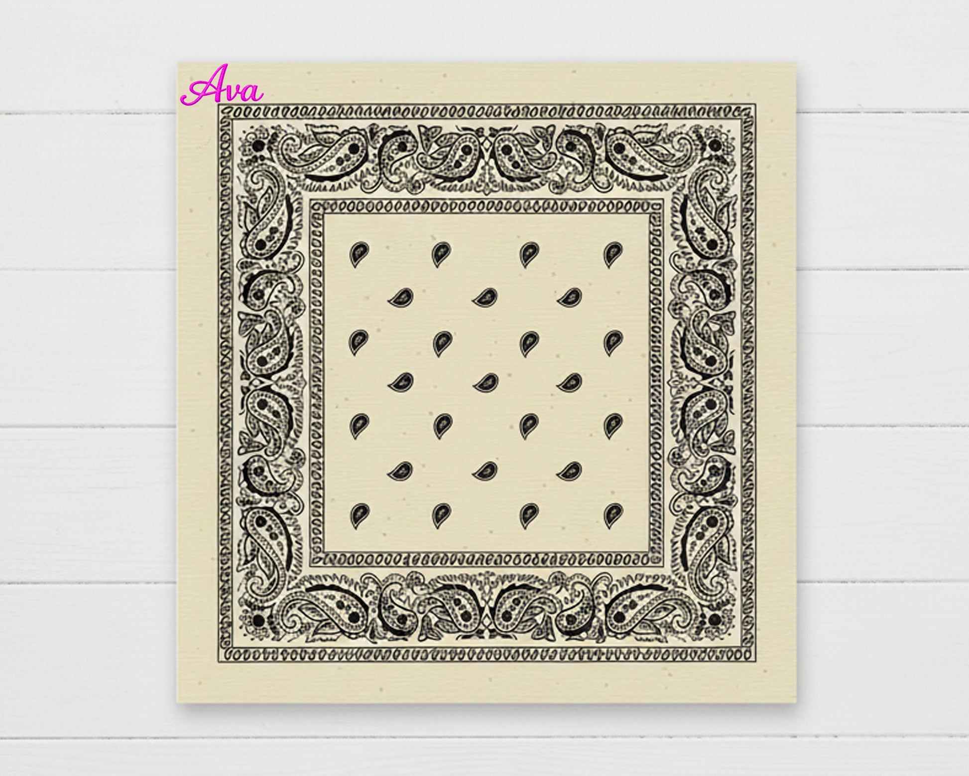 A cream-colored cotton paisley bandana with the name "Ava" personalized in a vibrant pink chain stitch script in the corner.