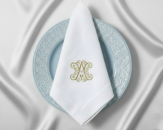 Personalized embroidered linen napkin with elegant gold monogram for luxury dining table