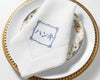 Personalized embroidered linen table napkin displayed on elegant wedding place setting