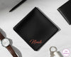 A personalized black cotton handkerchief with the name "Noah" custom-applied in a shimmering rose gold vinyl script.