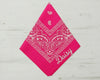 A bright pink paisley bandana featuring the custom name "Daisy" in white embroidery.
