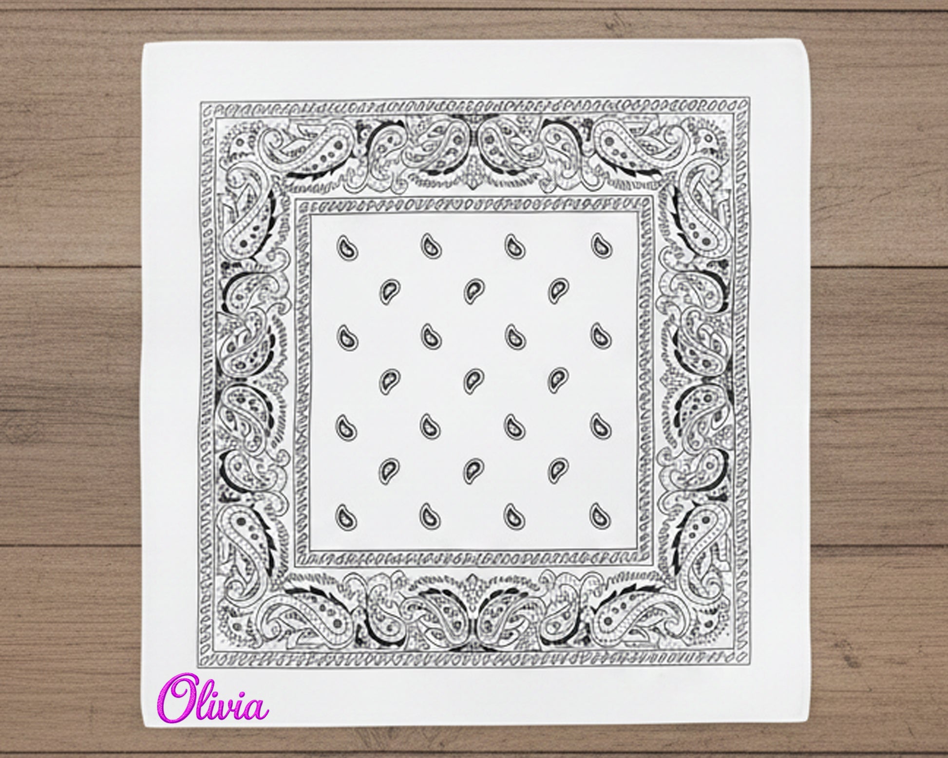 A stack of earth-toned western handkerchiefs in sage green, tan, and forest green with various custom names in chain stitch.