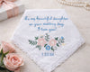 Embroidered wedding handkerchief with floral design and personalized text on a light background.