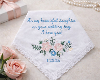 Embroidered wedding handkerchief with floral design and personalized text on a light background.