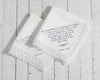 White cotton dinner napkin with an elegant sage green embroidered bow and personalized serif monogram