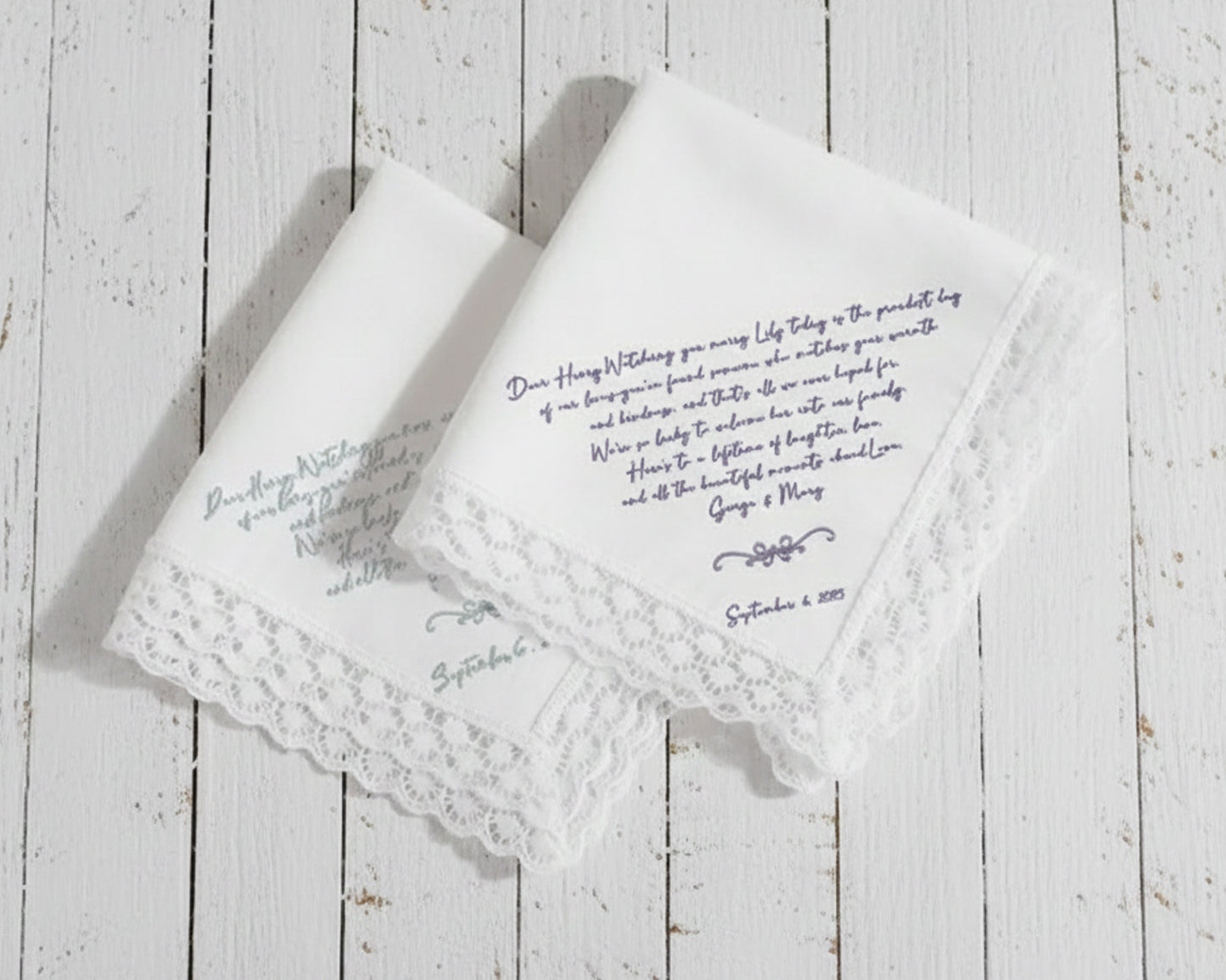 White cotton dinner napkin with an elegant sage green embroidered bow and personalized serif monogram