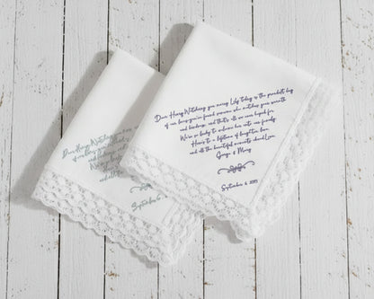 White cotton dinner napkin with an elegant sage green embroidered bow and personalized serif monogram