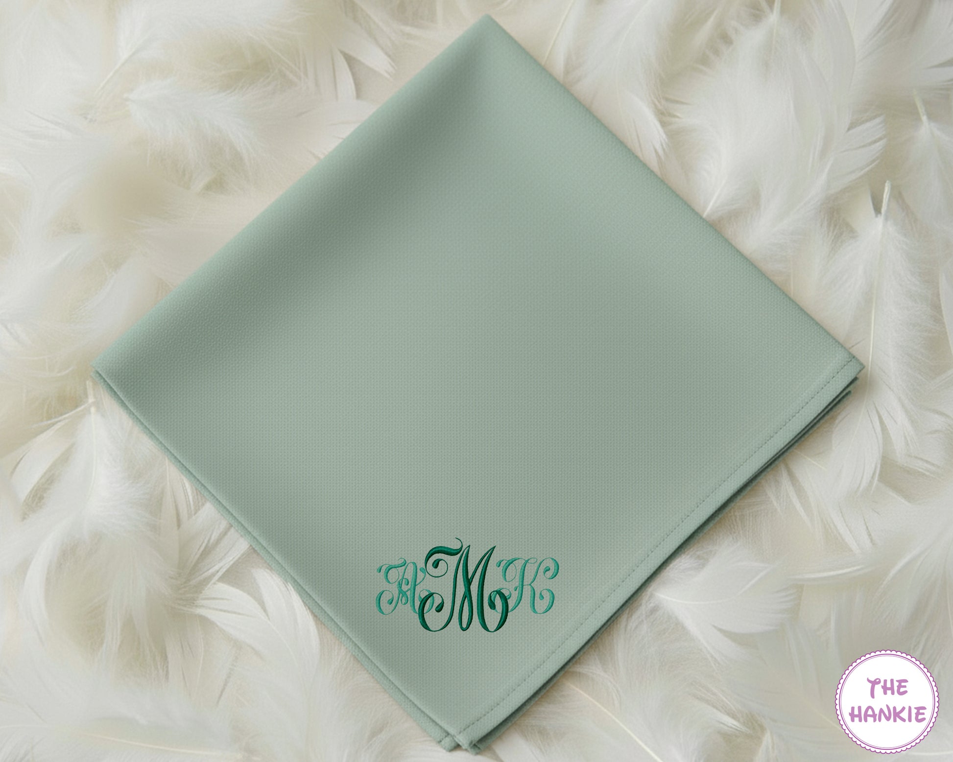 A sage green cotton handkerchief personalized with a sophisticated three-initial script monogram in a deep forest green embroidery.