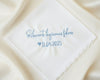 A customized 100% cotton handkerchief featuring the Spanish sentiment for happy tears and a wedding date, placed on a rustic dark wood surface.