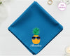 A deep sea blue cotton handkerchief personalized with "Theodore" below a pineapple wearing blue sunglasses.
