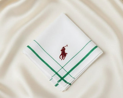A crisp white U.S. Polo Assn. cotton pocket square featuring green striped borders and a red embroidered horseman logo.