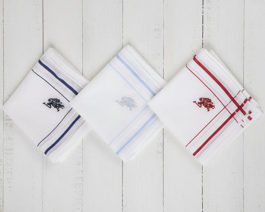 A crisp white U.S. Polo Assn. cotton pocket square featuring green striped borders and a red embroidered horseman logo.
