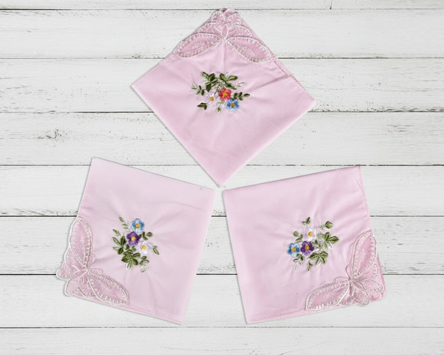 Two symmetrical fans of colorful embroidered handkerchiefs showcasing a full range of pastel tones