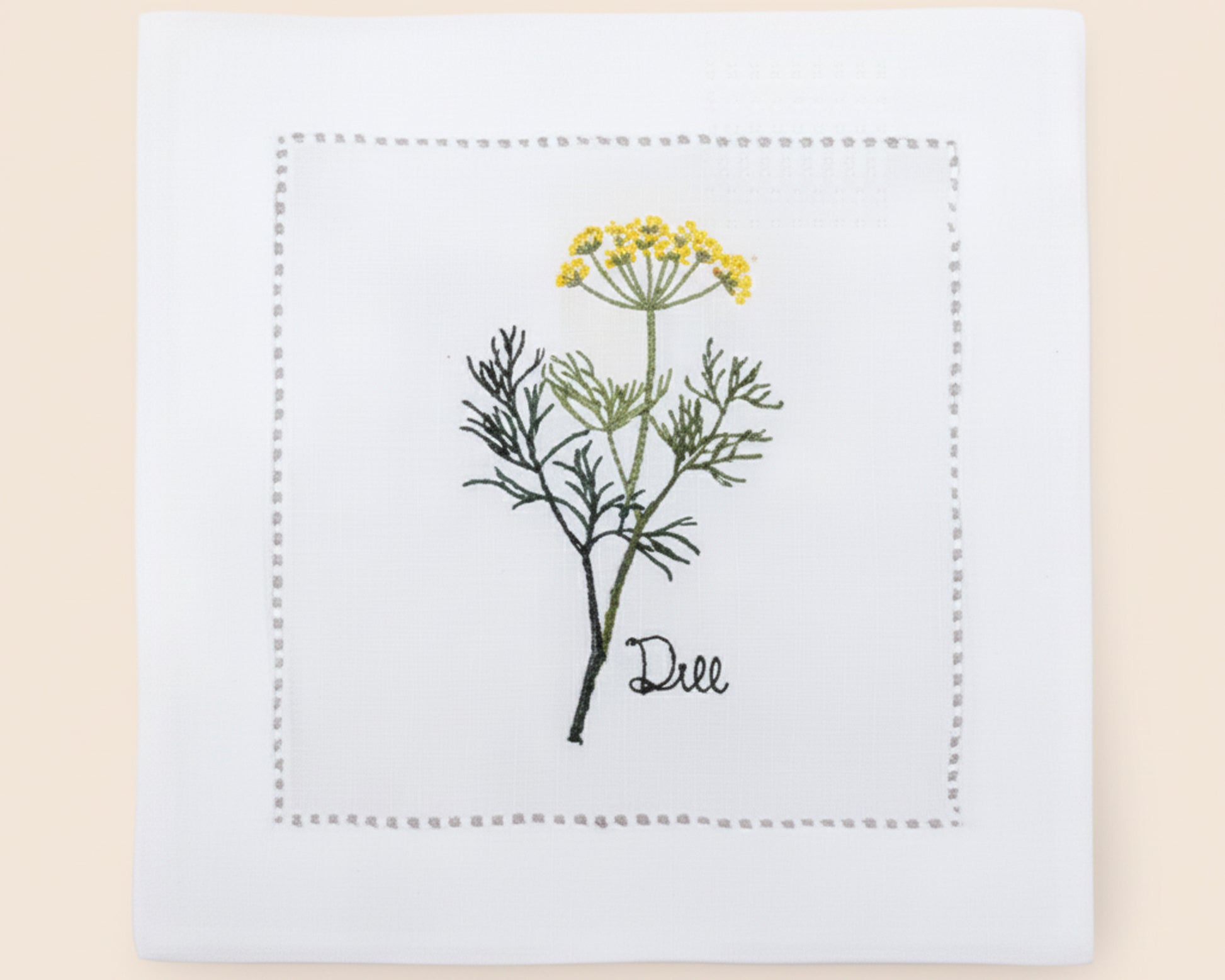Single white linen cocktail napkin featuring a detailed pink-flowered Oregano herb embroidery with a classic hemstitch border.
