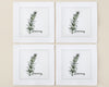 Single white linen cocktail napkin featuring a detailed purple-flowered Rosemary sprig embroidery with a hemstitch edge.