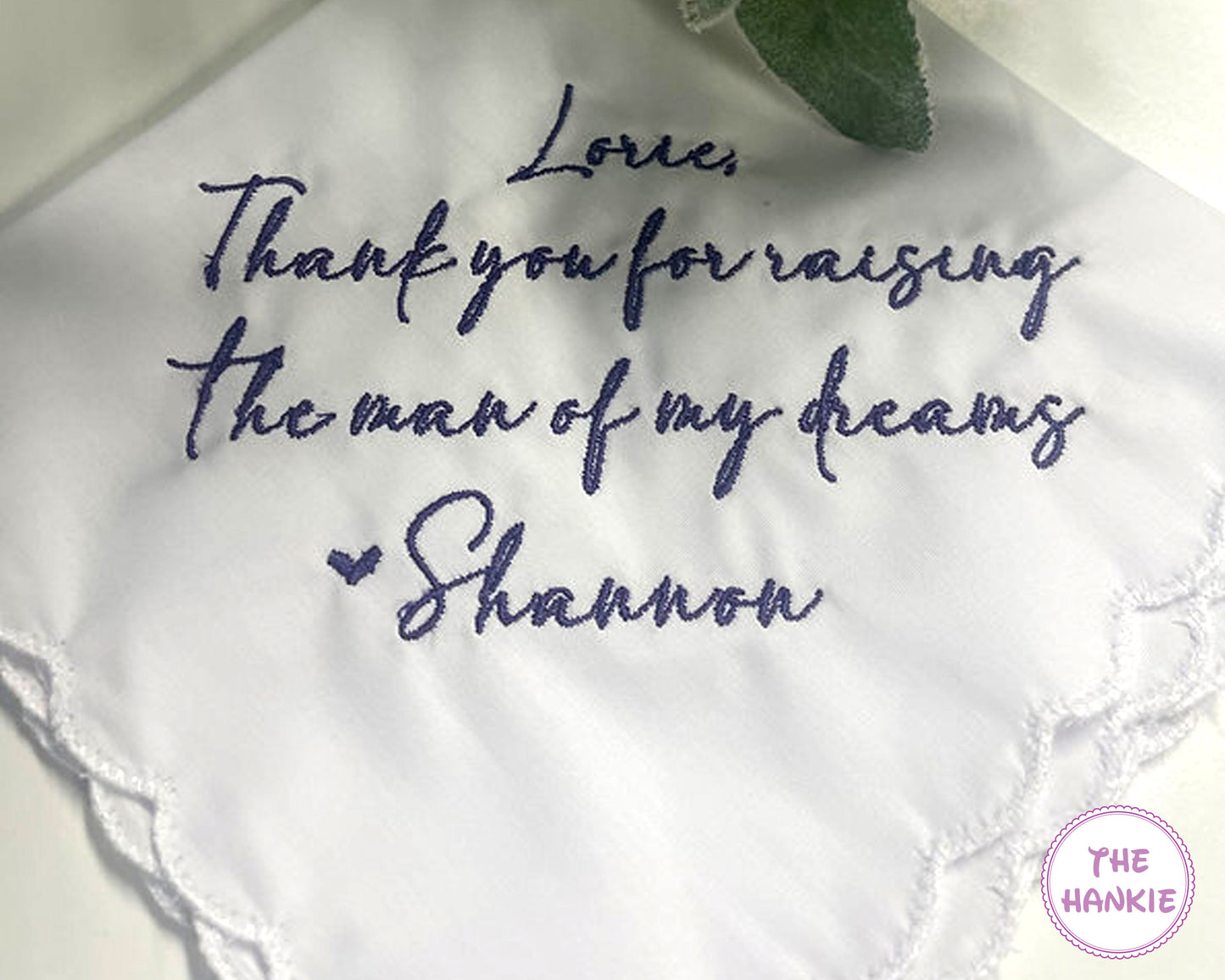 White handkerchief with embroidered message and 'The Hankie' logo.