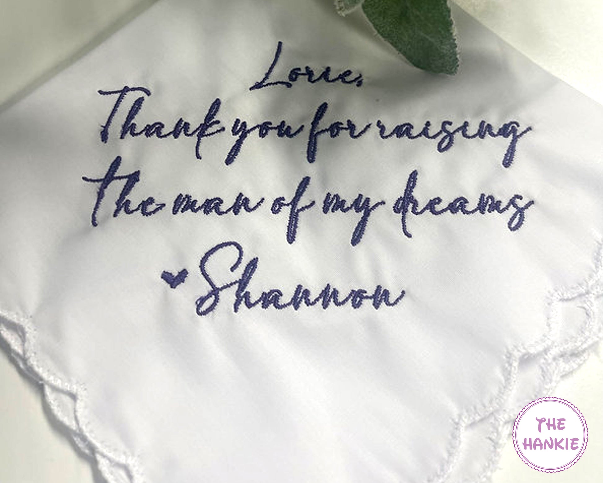 White handkerchief with embroidered message and 'The Hankie' logo.